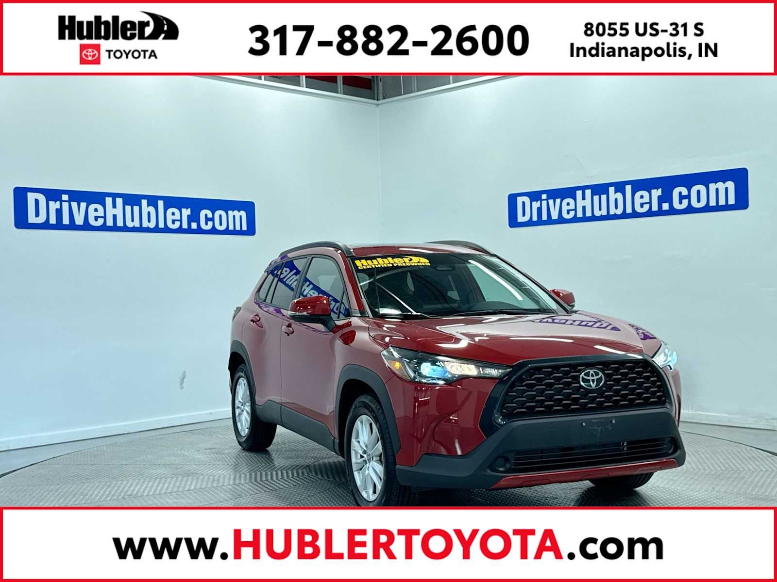 2024 Toyota Corolla Cross LE in Barcelona Red Metallic — front three-quarter view